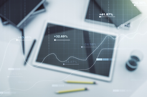 Multi exposure of stats data illustration and modern digital tablet on background, top view, computing and analytics concept