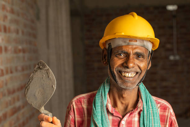 istock Senior worker smiling and working in construction building 2126846750