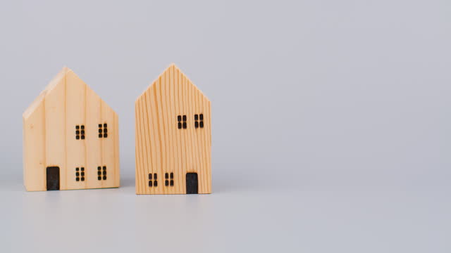 Wooden house, small model, moving back and forth, toy house, first house concept, home building project and home loan and money