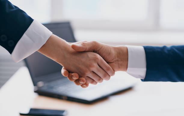 istock Business people shake hands on a light background office window laptop 2126874167