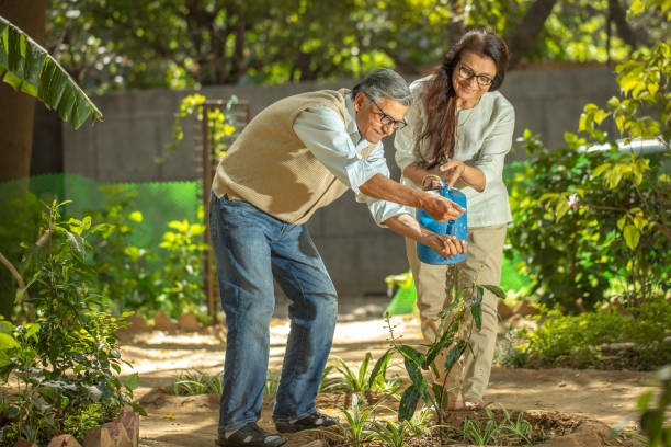 istock Happy retired elderly couple watering plants in backyard 2126886420