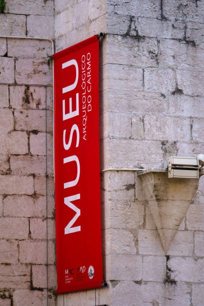 Carmo Archaeological Museum banner on an Ancient Stone Wall. Lisbon, Portugal. February 2, 2024.