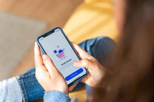 istock Young woman using shopping app on smartphone 2126953797