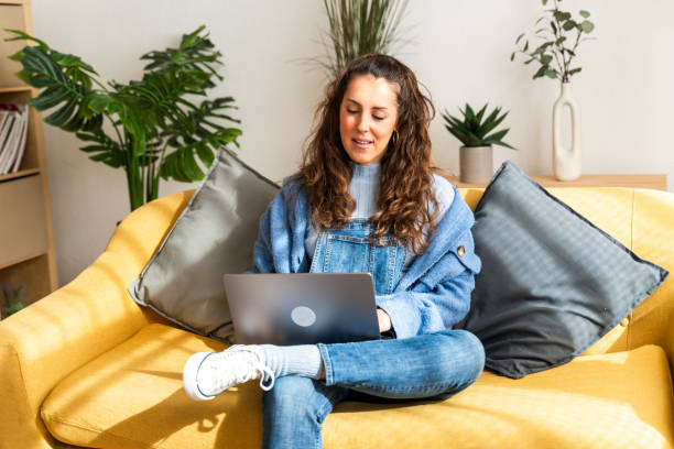 istock Casual woman working on laptop at home 2126954849