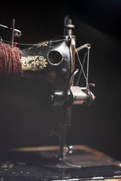 istock Old sewing machine stands on the table at home ready to work and sew. 2126982211