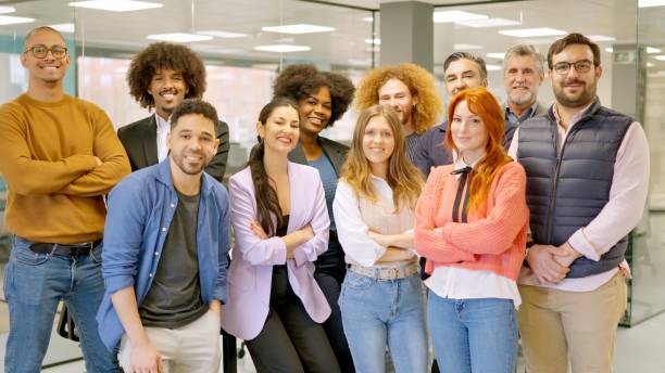istock Group of colleagues smiling at camera in a coworking space 2127086391