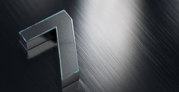 Metallic number seven on reflective stainless steel background