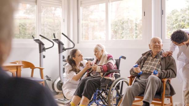 istock Physiotherapists talking to senior people while exercising in geriatrics 2127094575