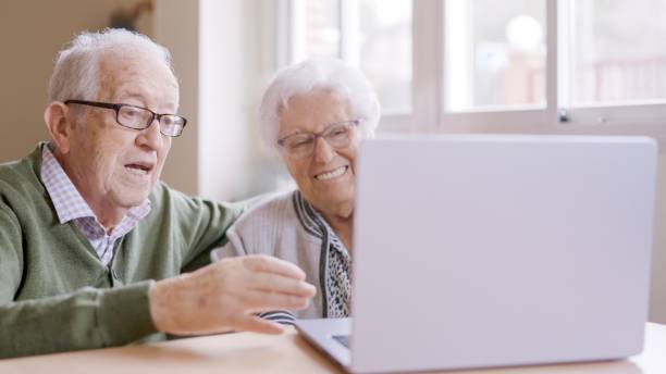 istock Senior people talking during online meeting using laptop in geriatric 2127095094
