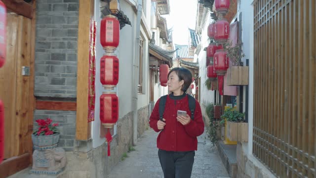 Woman searching for homestays in Lijiang ancient city,Yunnan,China.