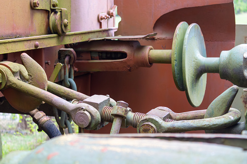 Closeup of an old-style train wagon coupling linking freight wagons