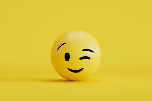 3d rendering of Emoji winking with smiley face on yellow background.