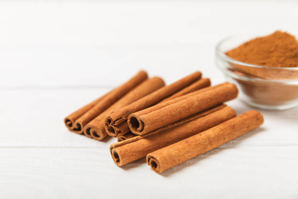 istock Cinnamon sticks on a textured wooden background. Cinnamon roll. Spicy spice for baking, desserts and drinks. Fragrant ground cinnamon. cinnamon powder Close-up. Place for text. copy space 2127122899