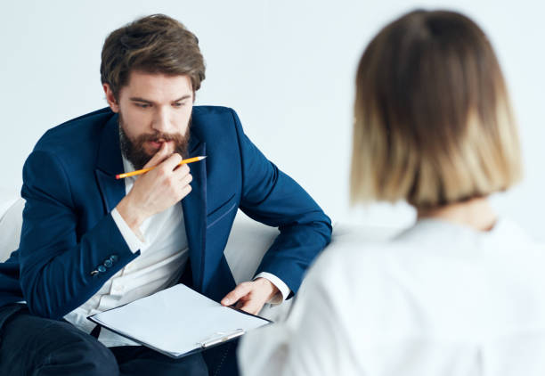 istock A man is a psychologist with documents and a woman at a doctor's appointment 2127131604