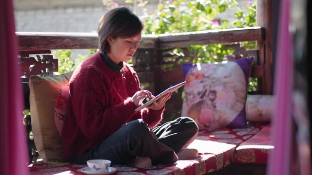 Woman Using Tablets in a classical Chinese Architectur