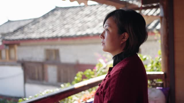 Woman  enjoying time of solitude and relaxation In a traditional Chinese architecture