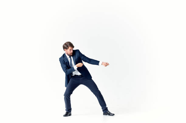 istock a man in a suit pulls a rope on a light background in full growth 2127183503