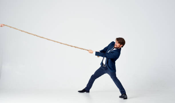 istock man with rope in hand on light background business finance 2127185075