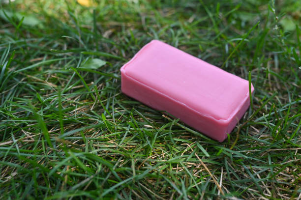 istock pink soap. On the green grass 2127205365