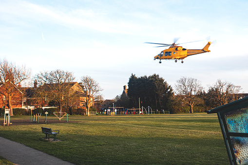 The Kent, Surrey and Sussex air ambulance taking off from the outfield of Hailsham Cricket Club in East Sussex, UK, with a patient onboard.  AgustaWestland AW169 L-NAC is the charitys backup helicopter and occasionally uses the cricket pitch to pick up seriously injured or critically ill people for hospital transfer.