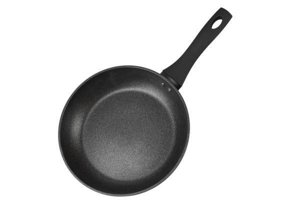 istock Black frying pan with nonstick surface isolated on white background, close-up. 2127239796