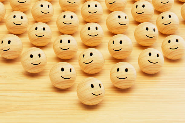3d rendering of wooden emoji with smiley face.