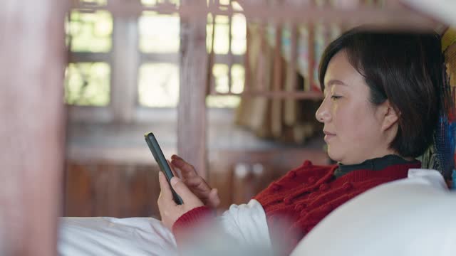 Woman  using smartphones in a traditional Chinese architecture