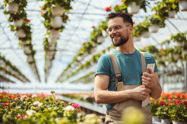 istock Florist Checking Flowers Condition in Garden Center 2127420740