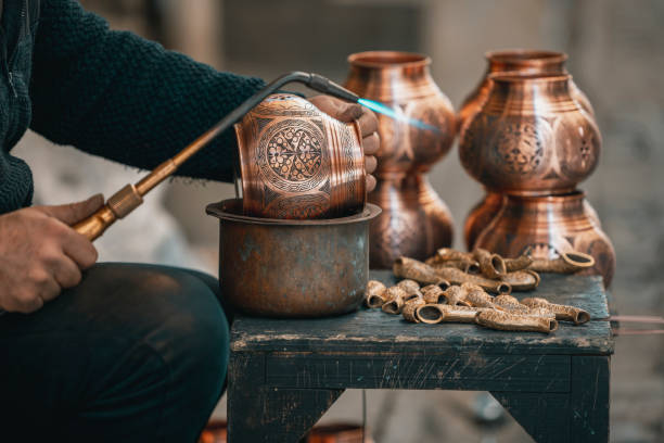 istock Copper Crafting Handicraft, Tinning copper, Crafting copper goods by artisans in the bazaar, using flame for soldering copper 2127441491