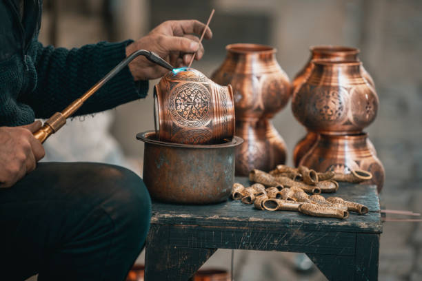 istock Copper Crafting Handicraft, Tinning copper, Crafting copper goods by artisans in the bazaar, using flame for soldering copper 2127441496