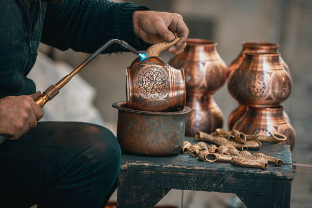 istock Copper Crafting Handicraft, Tinning copper, Crafting copper goods by artisans in the bazaar, using flame for soldering copper 2127446109