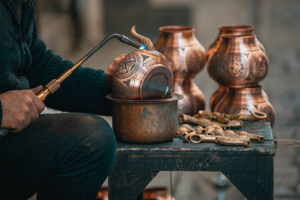 istock Copper Crafting Handicraft, Tinning copper, Crafting copper goods by artisans in the bazaar, using flame for soldering copper 2127446121