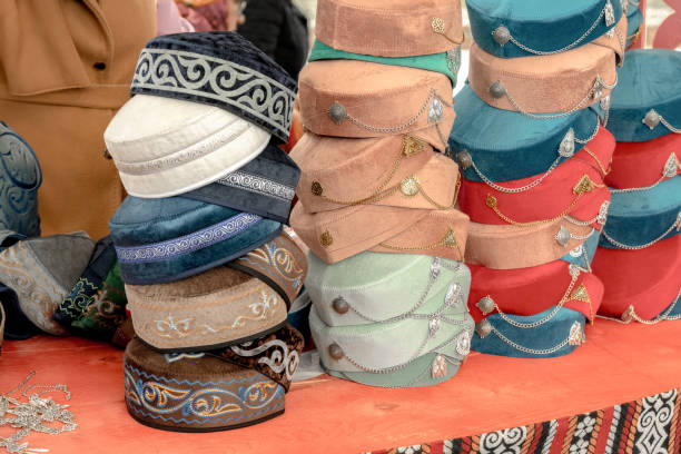 Traditional Asian headdresses from a multicolored felt with an embroidered colored thread of national ornament. Close-up