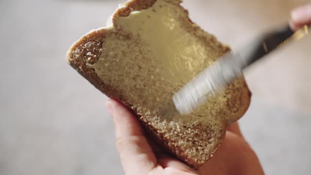 Spreading Butter on Fresh Bread Slice