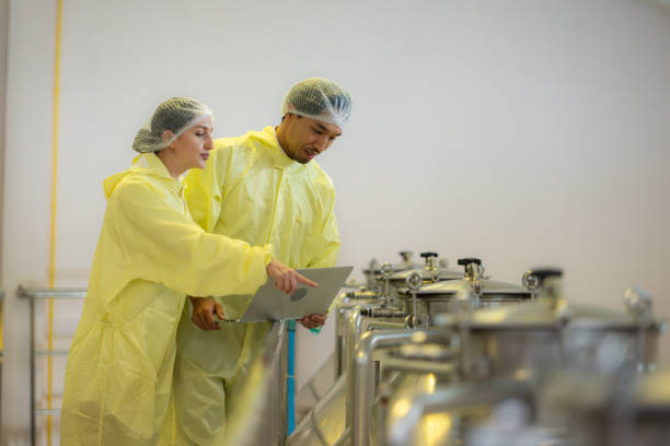 istock Mature female and male researchers and developers working in winery, Testing wine that has been fermented for a while. 2127470478