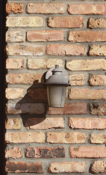 istock a small lamp is on a brick wall by the fire 2127474102