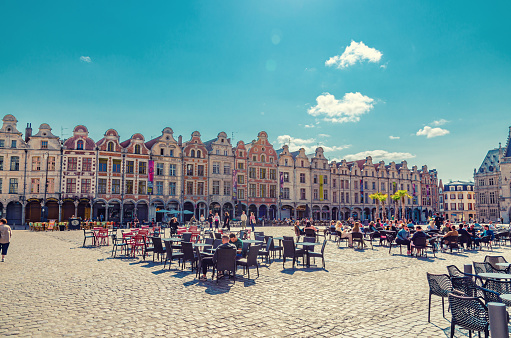 Arras, France, July 3, 2023: Flemish-Baroque-style townhouses buildings on Petite market Place des Heros Heroes Square in historical center, Artois, Pas-de-Calais department, Hauts-de-France Region