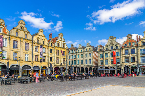 Arras, France, July 3, 2023: historical city center with Flemish-Baroque-style townhouses buildings on La Petite market Heroes Square, blue sky in summer day, Artois, Pas-de-Calais department
