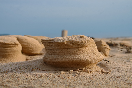 Natural sand sculptures made by wind on the Baltic sea beach. Gulf of Riga in Latvia Landscape. Blue Sky and sea on the background. Copy Space. Selective focus.