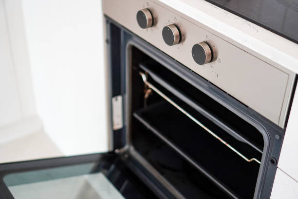 istock Side view of a large electric oven installed in a wall-mounted kitchen for a small room 2127521024