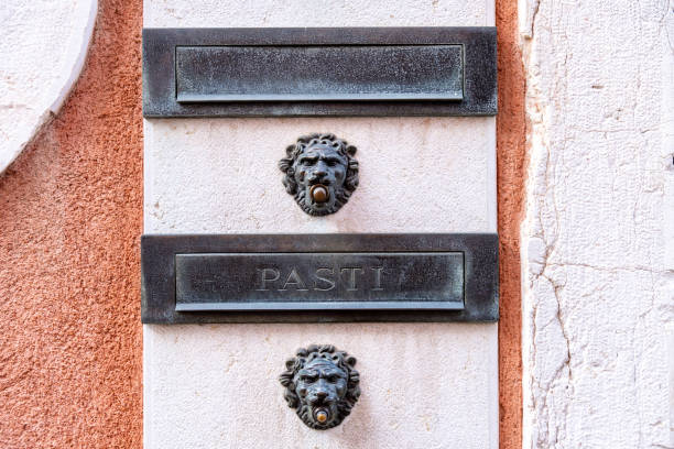 Venice, Veneto - Italy - 06-10-2021: Elegant lion head mail slots adorn a Venetian building's facade