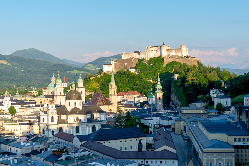 Salzburg, Salzburg - Austria - 06-17-2021: Elevated view of Salzburg with Hohensalzburg Fortress dominating the skyline amidst green hills