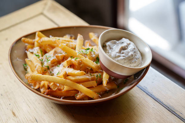 Fries with parmesan cheese and truffled mayonnaise sauce A plate of fries chips topped with parmesan cheese and truffled mayonnaise is a delicious and indulgent snack or side dish. fried potato stock pictures, royalty-free photos & images