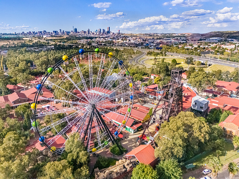Gold Reef City which includes the casino and an amusement park south of Johannesburg city with Johannesburg cityscape in the distance.