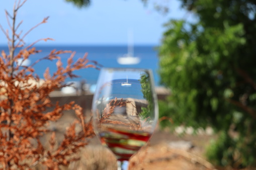 Yacht pictured via a wine glass on the the South Atlantic British Overseas Territory of Ascension Island