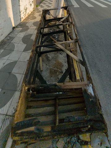 Vandalism very common in Brazil with sofa and trash burned on sidewalk near shopping center