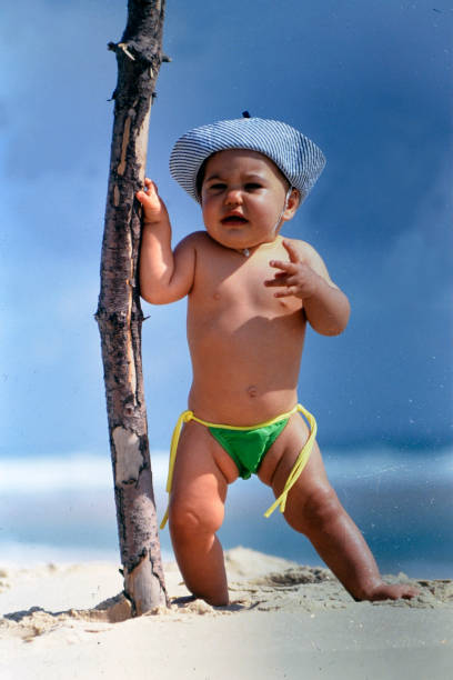 istock baby girl on the beach with her bob 2127632492