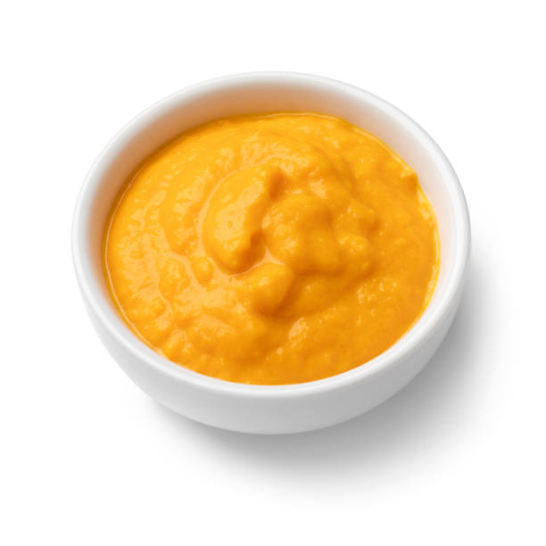 istock Single white bowl with Peruvian Aji Amararillo pepper sauce close up on white background 2127653724