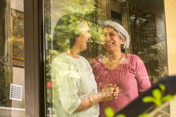 istock Happy senior friends discussing seen through window 2127655654