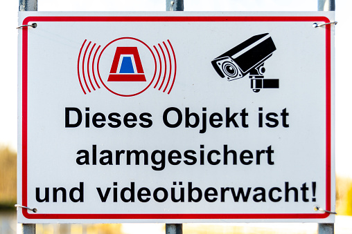 Brieselang, Brandenburg - Germany - 03-21-2021: Warning sign indicating area is alarm-secured and under video surveillance
